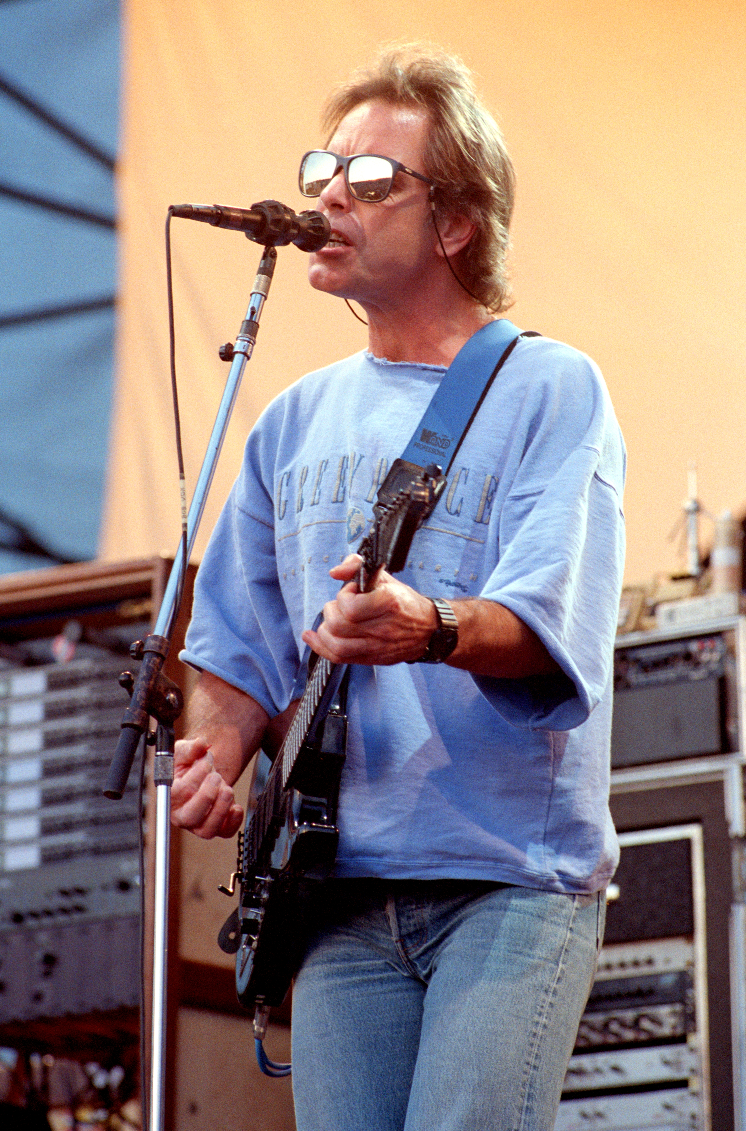 Bob Weir of the Grateful Dead performing on guitar and singing into a microphone.
