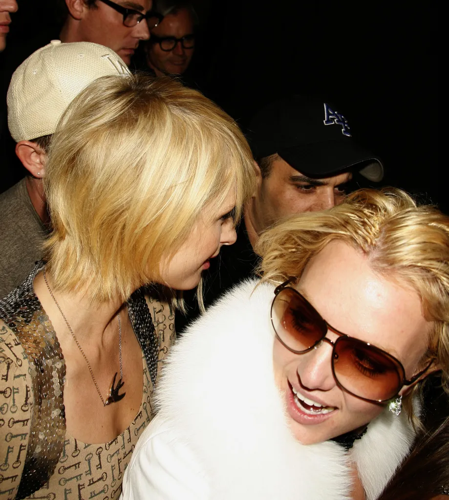 Paris Hilton, in a sequined shirt and bird necklace, and Britney Spears, wearing a white fur coat and sunglasses, attend an event.