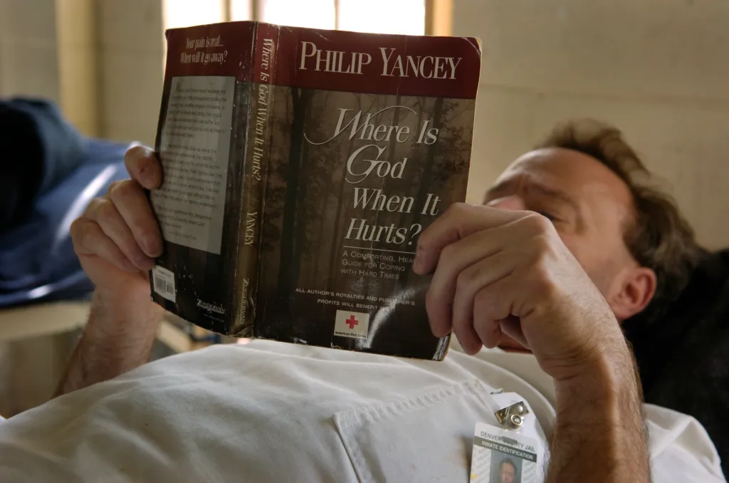  A Denver County Jail inmate a reads a book by Philip Yancey called "Where Is God When It Hurts?."