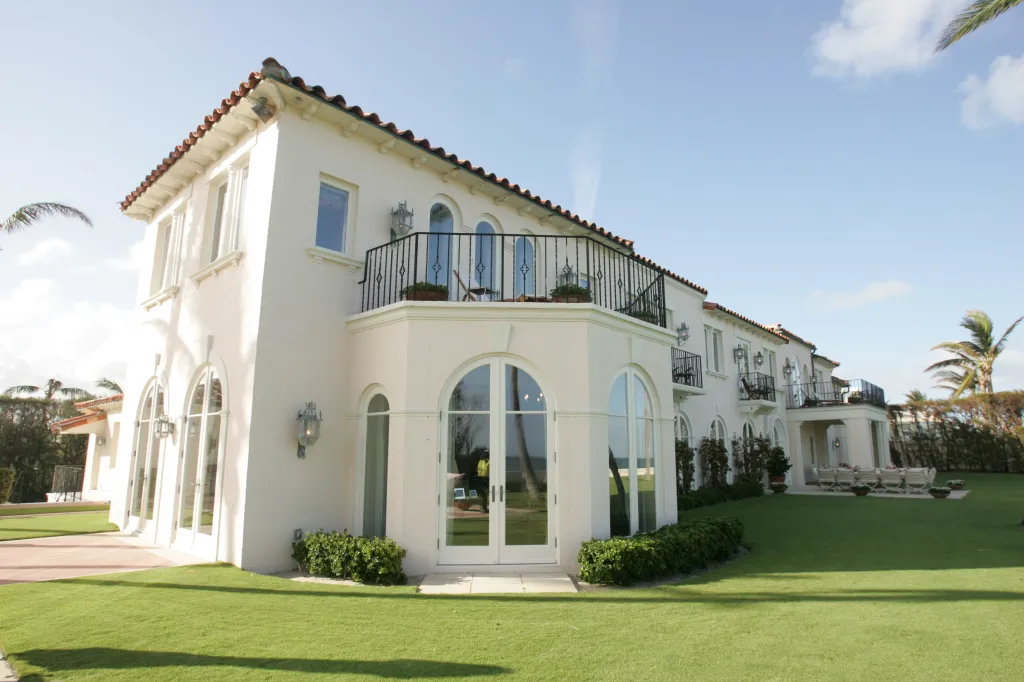 The exterior of the former Kennedy family's Palm Beach, Florida oceanfront holiday retreat home, with a manicured lawn in the foreground.