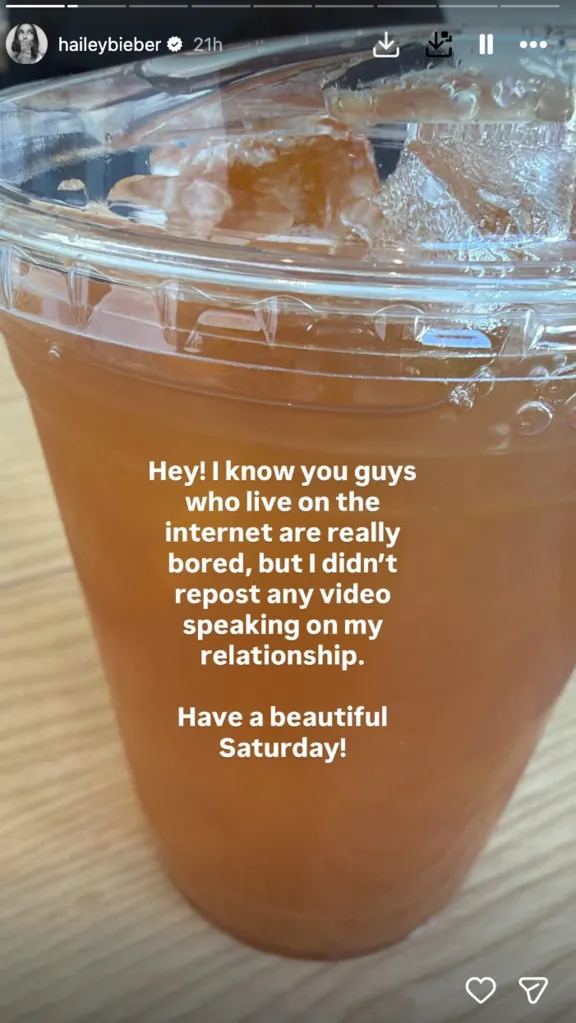 A social media post from Hailey Bieber, on a photo of an iced drink, denying she reposted a video about her relationship.