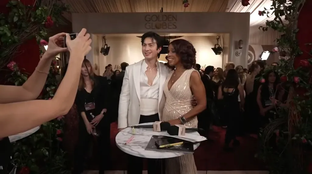 Hudson Williams and Gayle King posing for a photo at the Golden Globes.