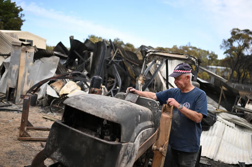 Harcourt CFA first lieutenant Tyrone Rice inspects damage to his property amid bushfires.
