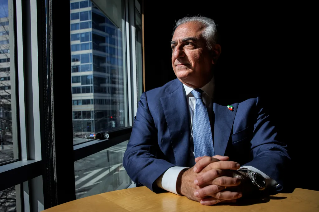 Iran's exiled crown prince Reza Pahlavi looks out a window.