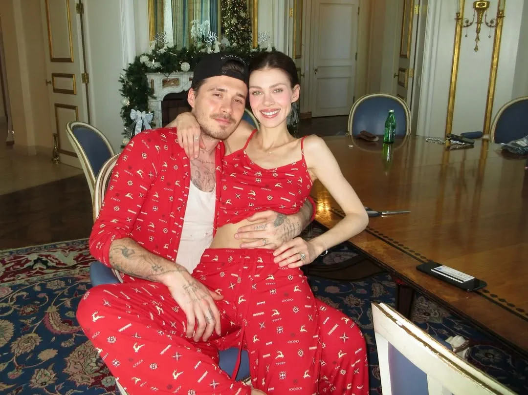 Nicola Peltz Beckham and Brooklyn Beckham in matching red Christmas pajamas.