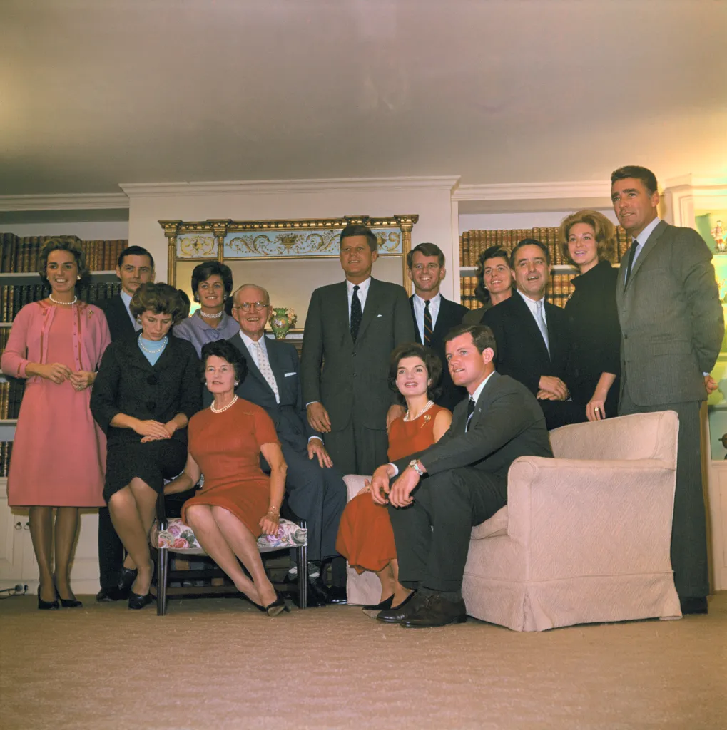 Family portrait of President-elect John F. Kennedy and his family, with most family members smiling and dressed in formal attire.