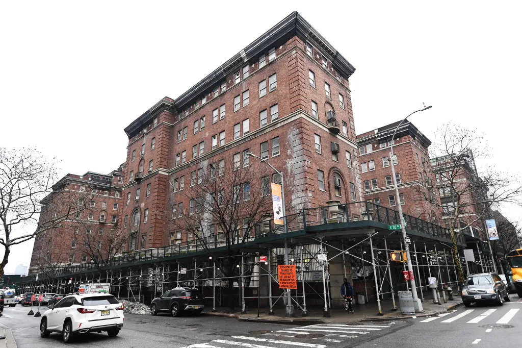 The Bellevue Men's Shelter, a large brick building under scaffolding, in New York City.