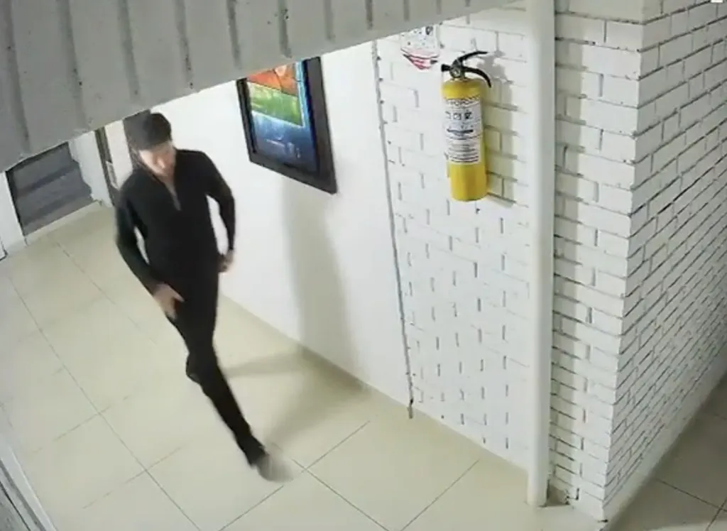 CCTV footage of Nuchem Yasir Ebeth, the dismembered American rabbi, walking in a hallway.