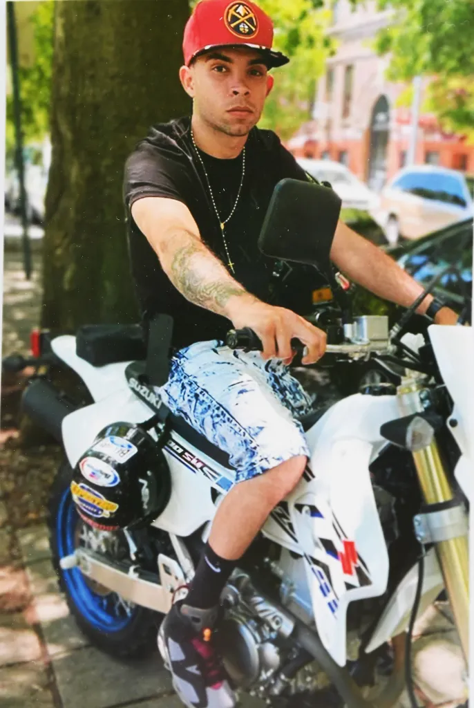 Photo of Eric Duprey sitting on a moped.