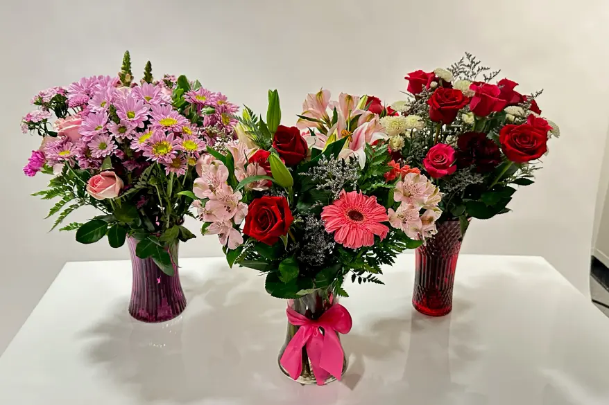 A group of flowers in vases from 1-800 Flowers.