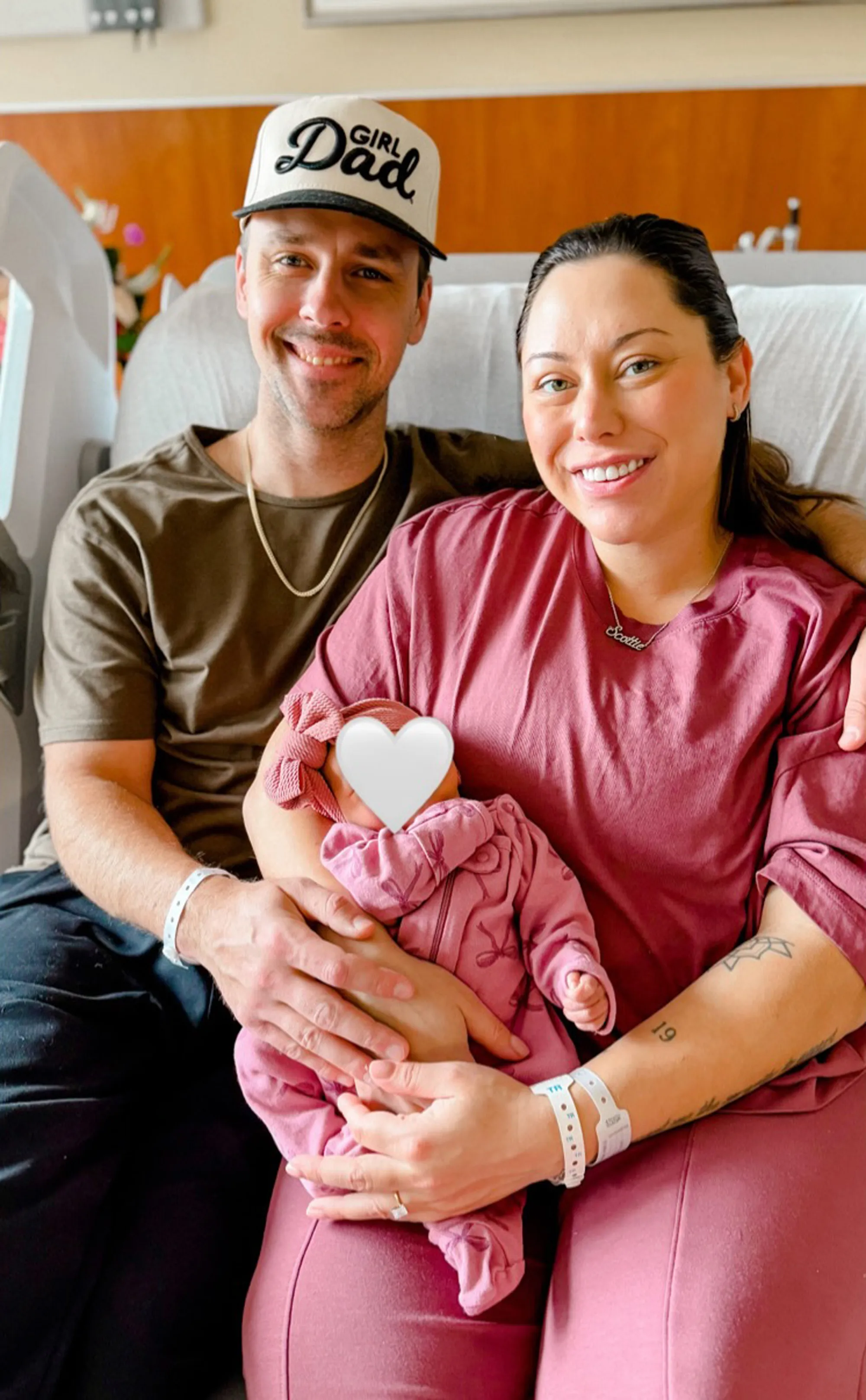 Alaina Scott and Matt Moeller with their newborn daughter, Scottie Marie, in a hospital room.