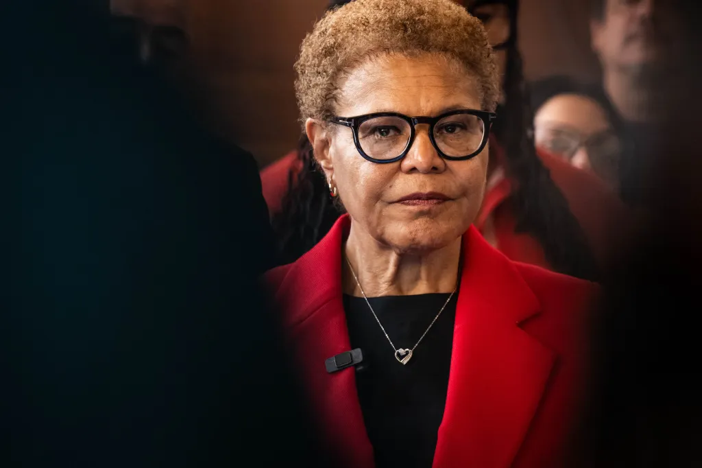 Karen Bass wearing glasses and a red jacket.