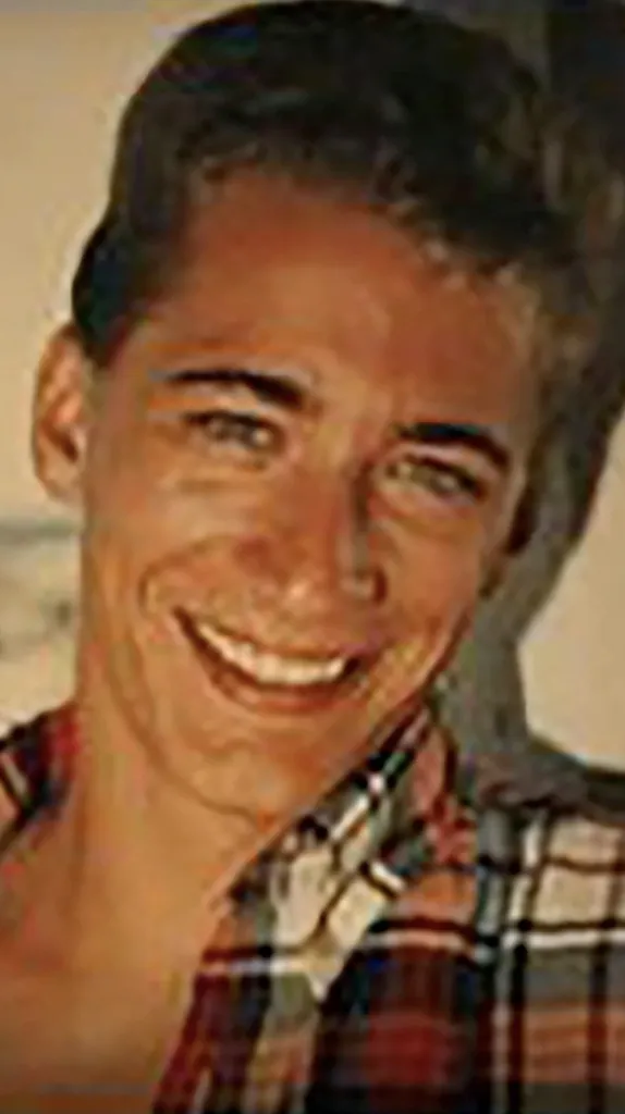 Garland "Andy" Atkinson smiling, wearing a plaid shirt.