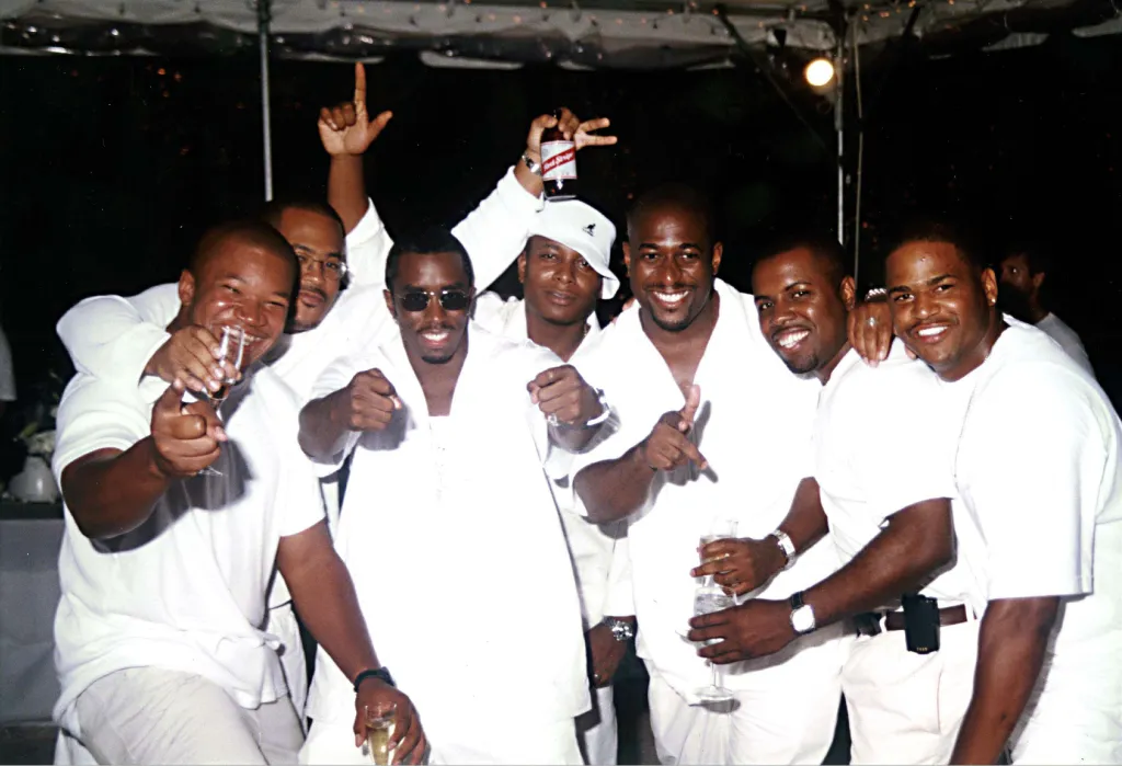 P. Diddy, Eagle Eye Cherry, and a group of men wearing white at a Labor Day party.