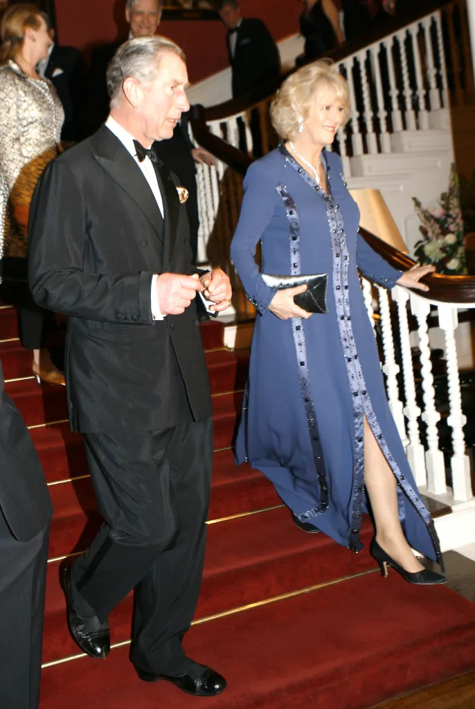 The Prince of Wales and Duchess of Cornwall descending a staircase.