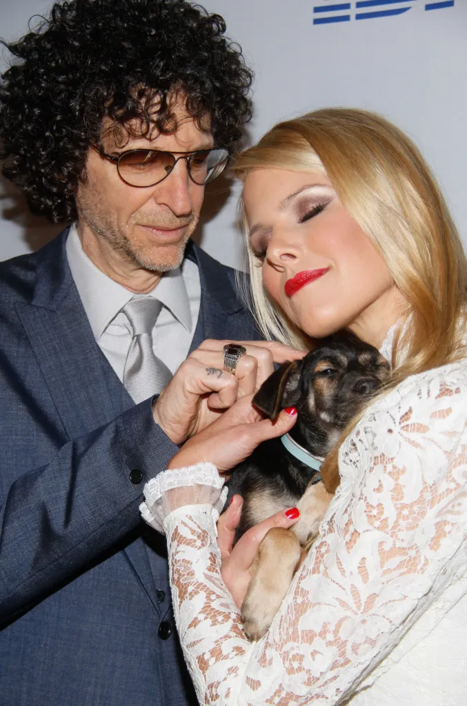 Howard Stern and Beth Stern hold a small puppy at the North Shore Animal League America 2014 Celebrity Gala.