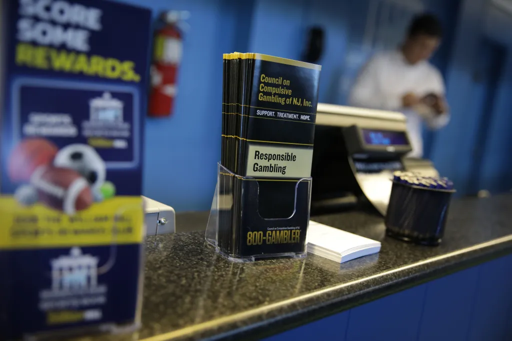 Brochures for "Responsible Gambling" and "Council on Compulsive Gambling of NJ" are displayed at the Monmouth Park Sports Book.