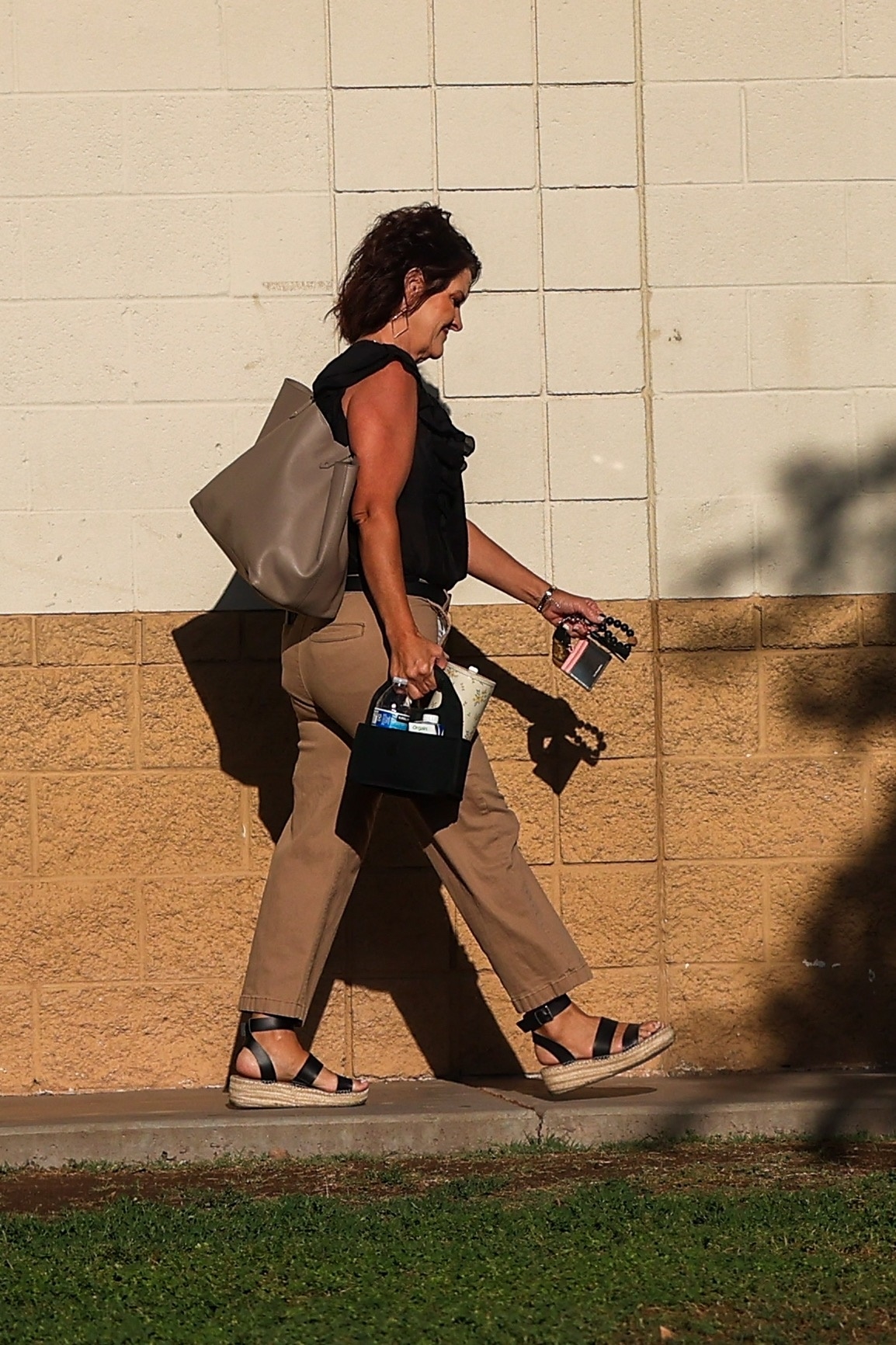 Amy Beck, mother of Noah Beck, was pictured heading to school weeks before being suspended for recording an inappropriate video with her son. 