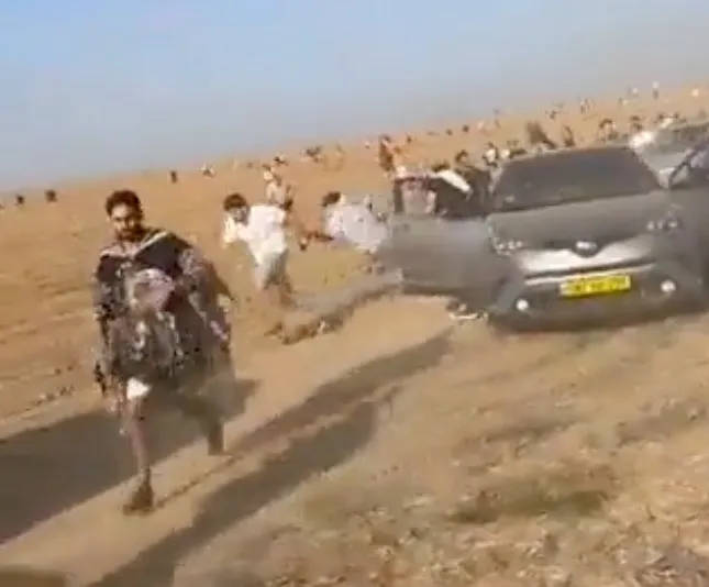 Attendees of the Tribe of Nova music festival running from a terrorist attack in Southern Israel.