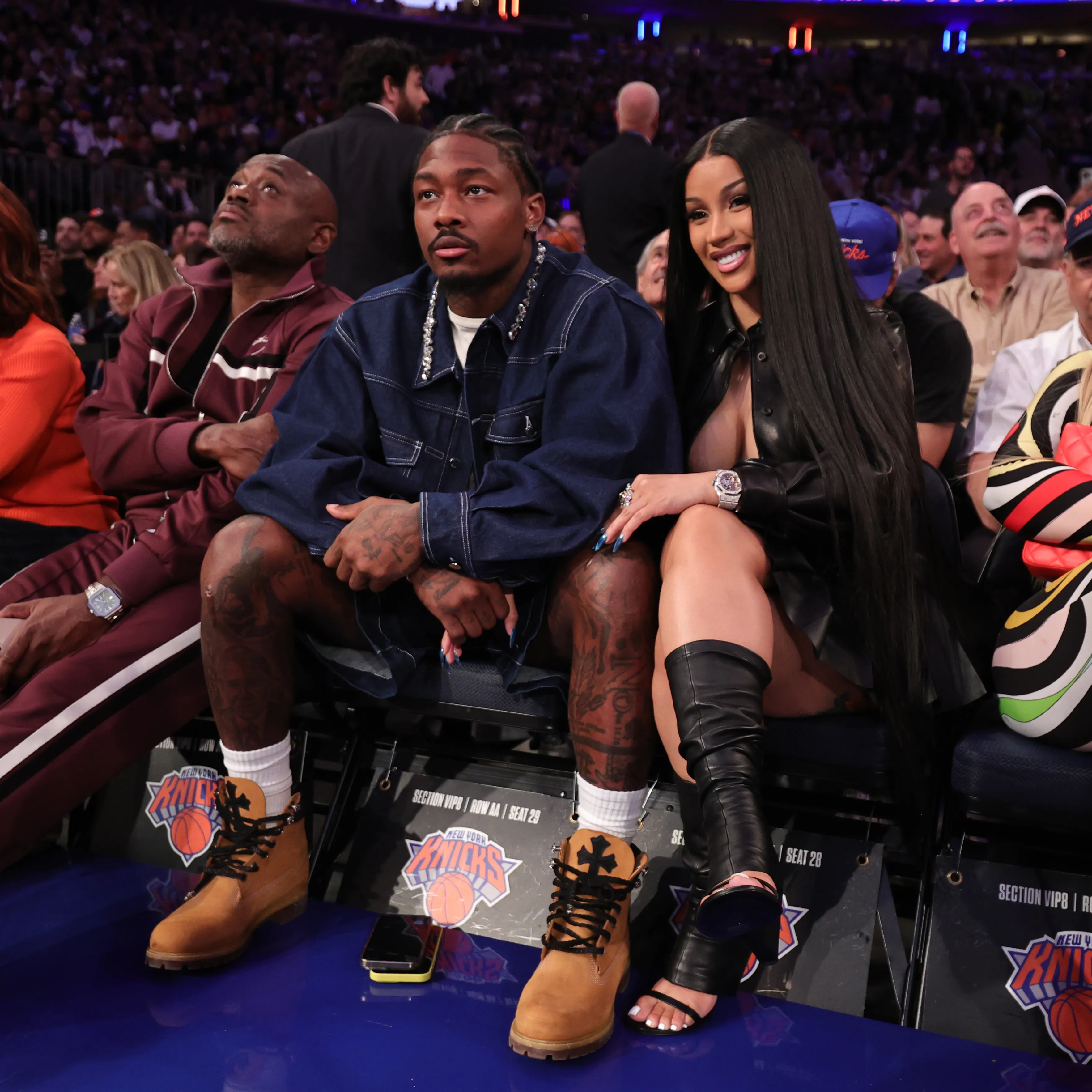 Stefon Diggs and Cardi B attending an NBA playoff game.