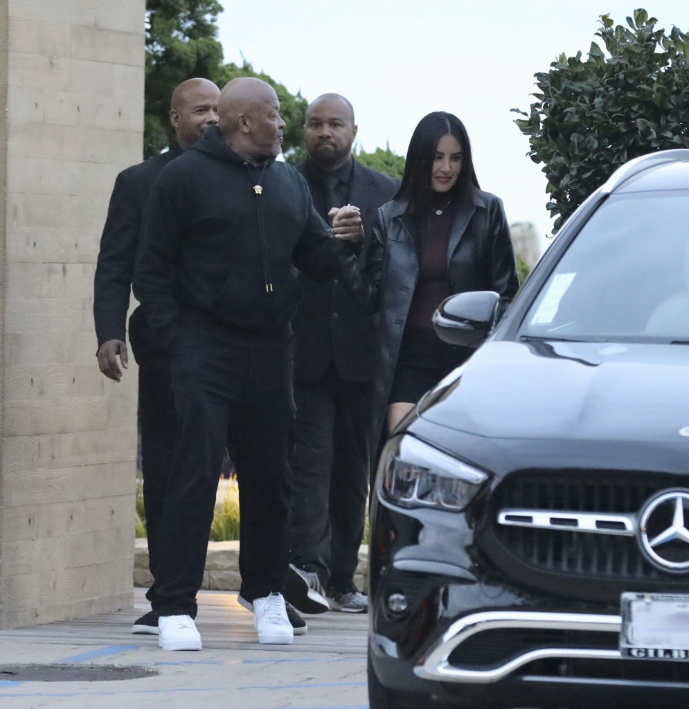 Dr. Dre and Michelle Saniei holding hands while leaving Nobu restaurant.
