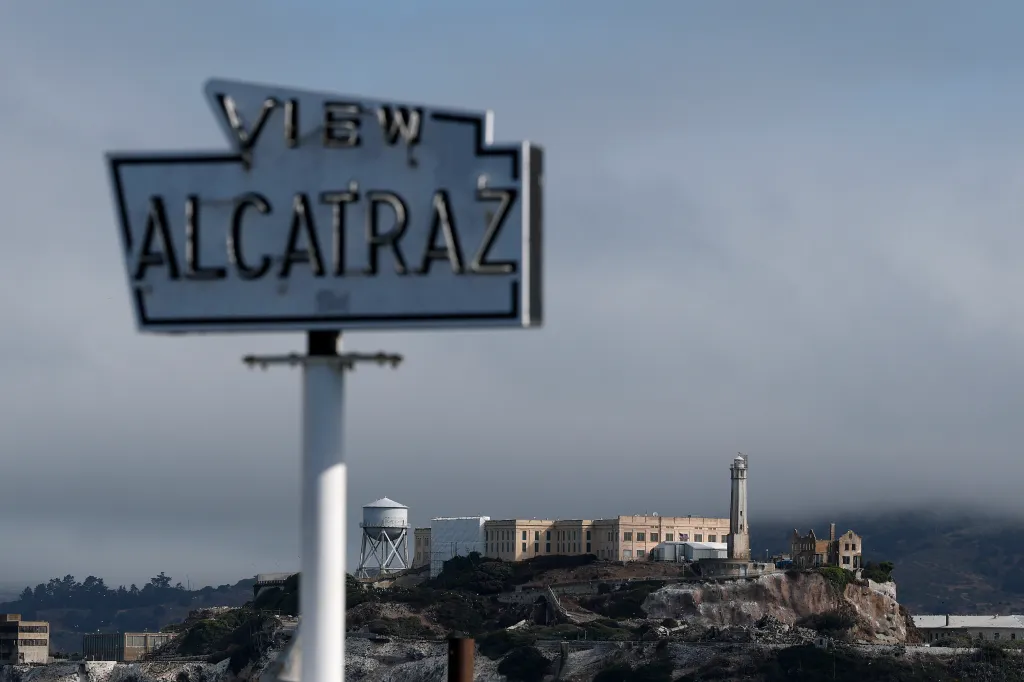 A view of Alcatraz Island with a blurry "VIEW ALCATRAZ" sign in the foreground.
