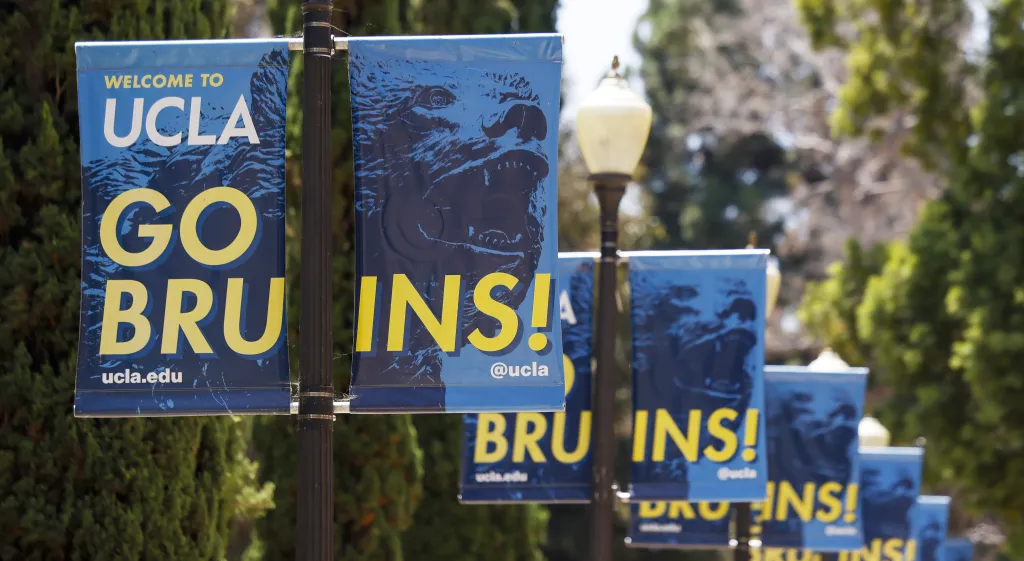 UCLA banners displaying "Welcome to UCLA" and "Go Bruins!" line a walkway.