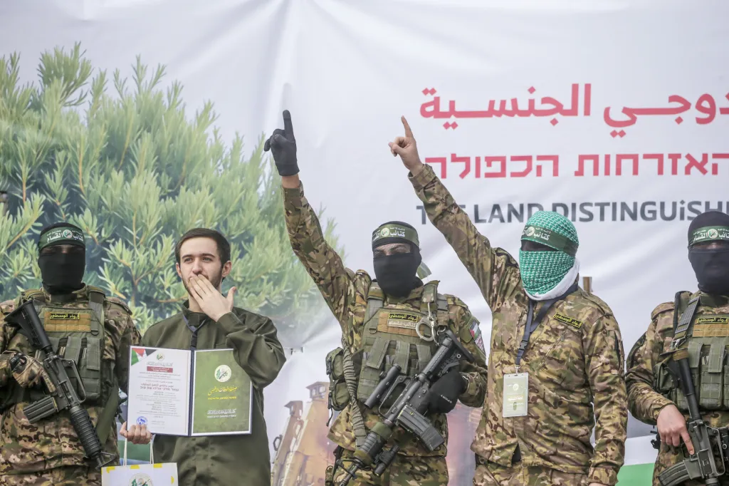 Hamas fighters escorting Israeli hostage Omer Shem Tov during a prisoner exchange in Al Nusairat refugee camp.