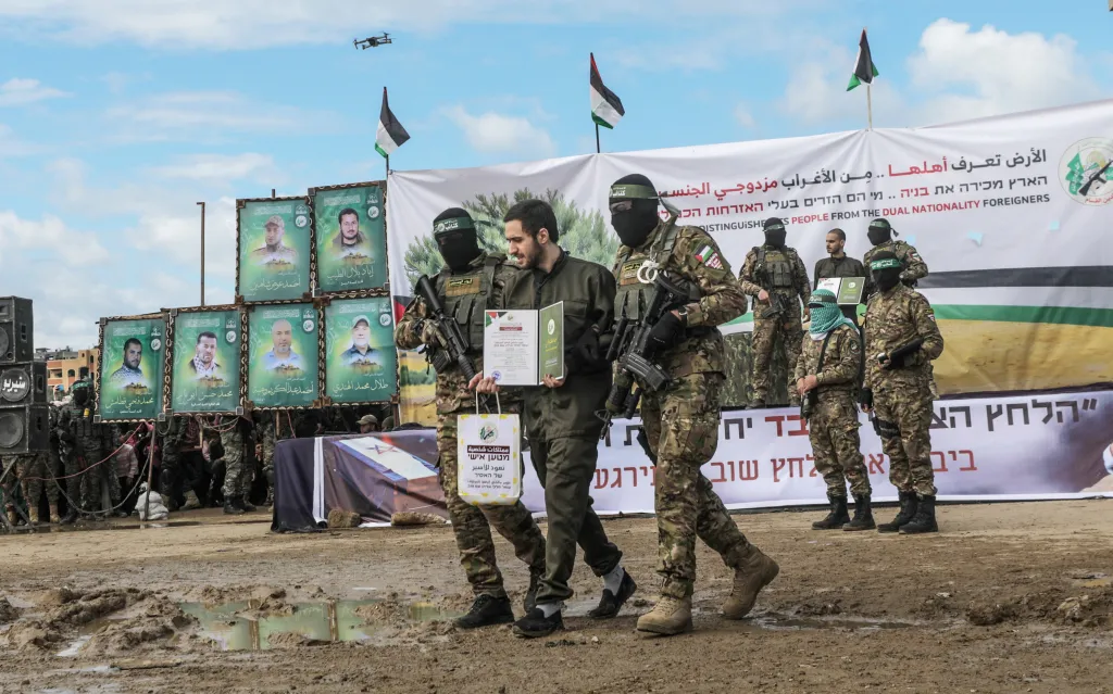 Hamas fighters escort Israeli hostage Omer Shem Tov during a prisoner exchange in Al Nusairat refugee camp.