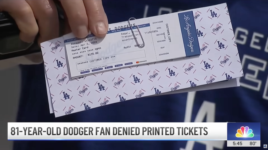 Hand holding a Dodgers paper ticket printed for "Segal" for a game on April 2, 2026.