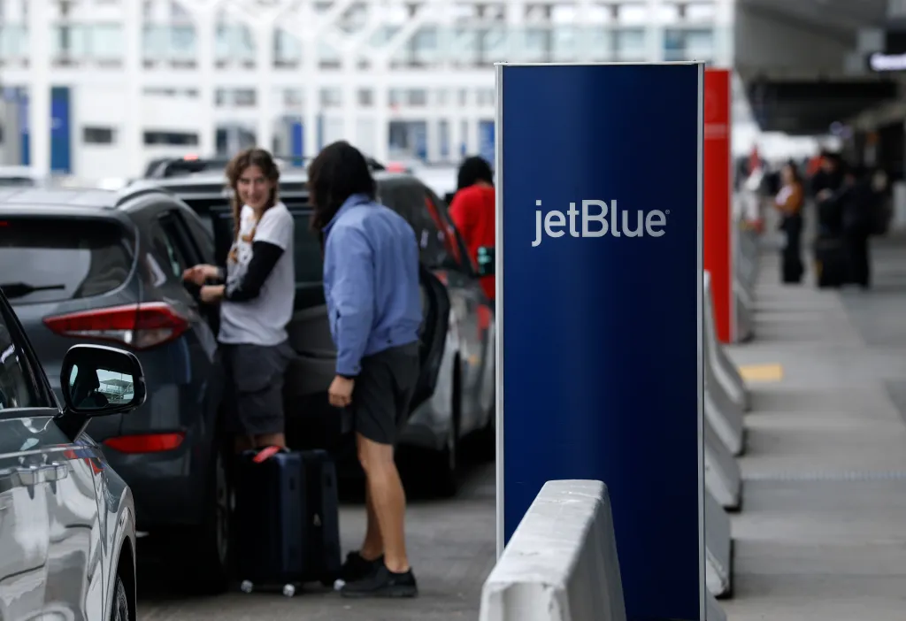 A JetBlue curbside bag check sign at Los Angeles International Airport.
