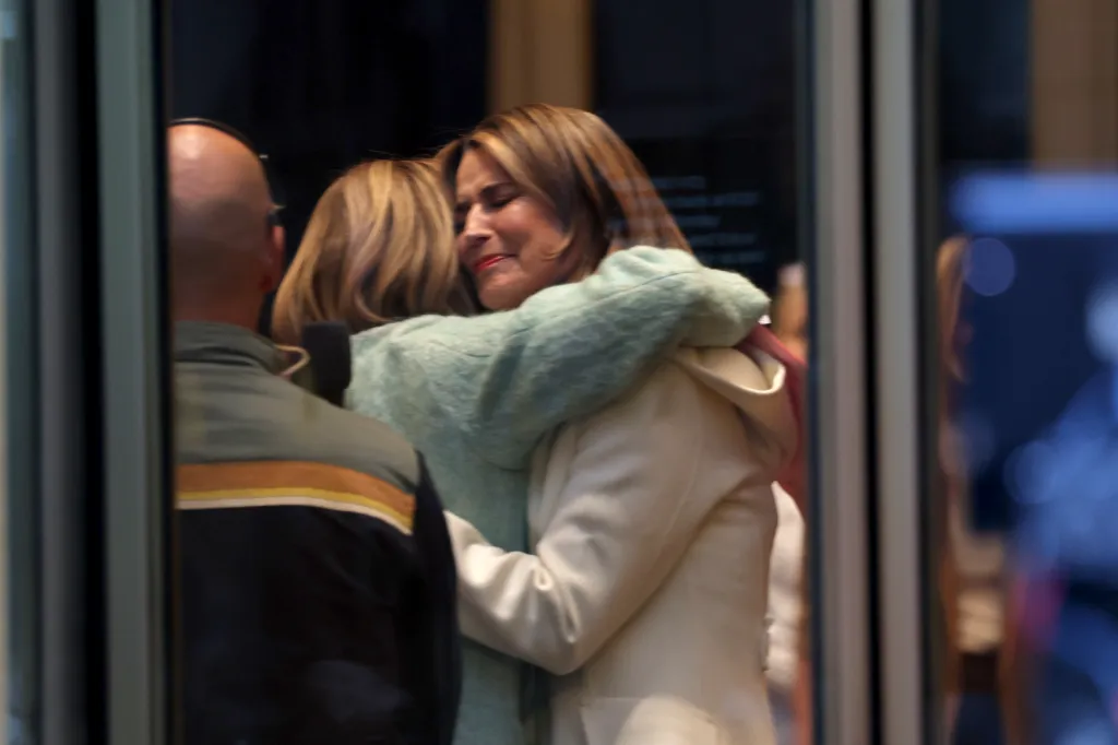 Savannah Guthrie embraces a colleague as she returns to the 