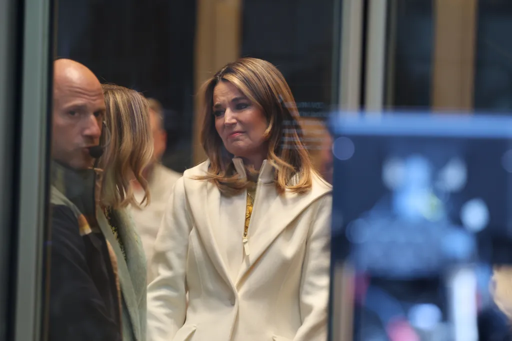 Savannah Guthrie appears emotional while being embraced by a colleague.
