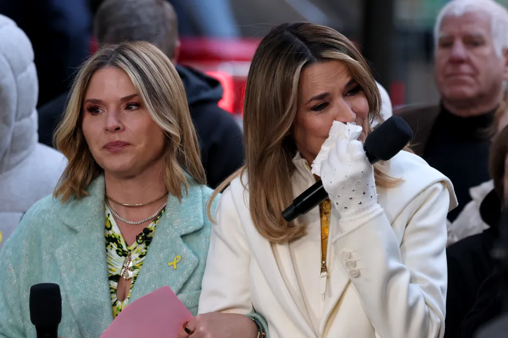 Savannah Guthrie crying into a tissue, with Jenna Bush Hager next to her.