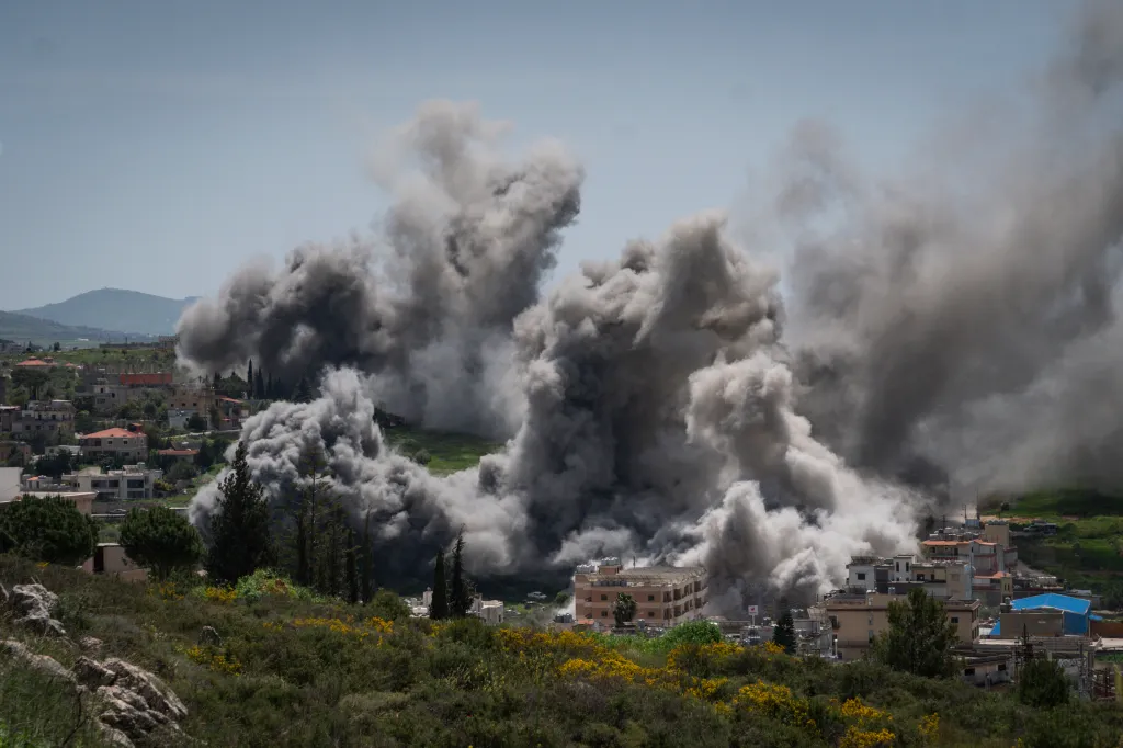 Heavy gray smoke rises over a town during an airstrike in Nabatieh, Lebanon.