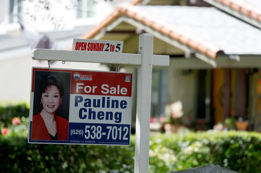 A "For Sale" sign for "Pauline Cheng" with contact information and an "Open Sunday 2 to 5" sign in front of a house.