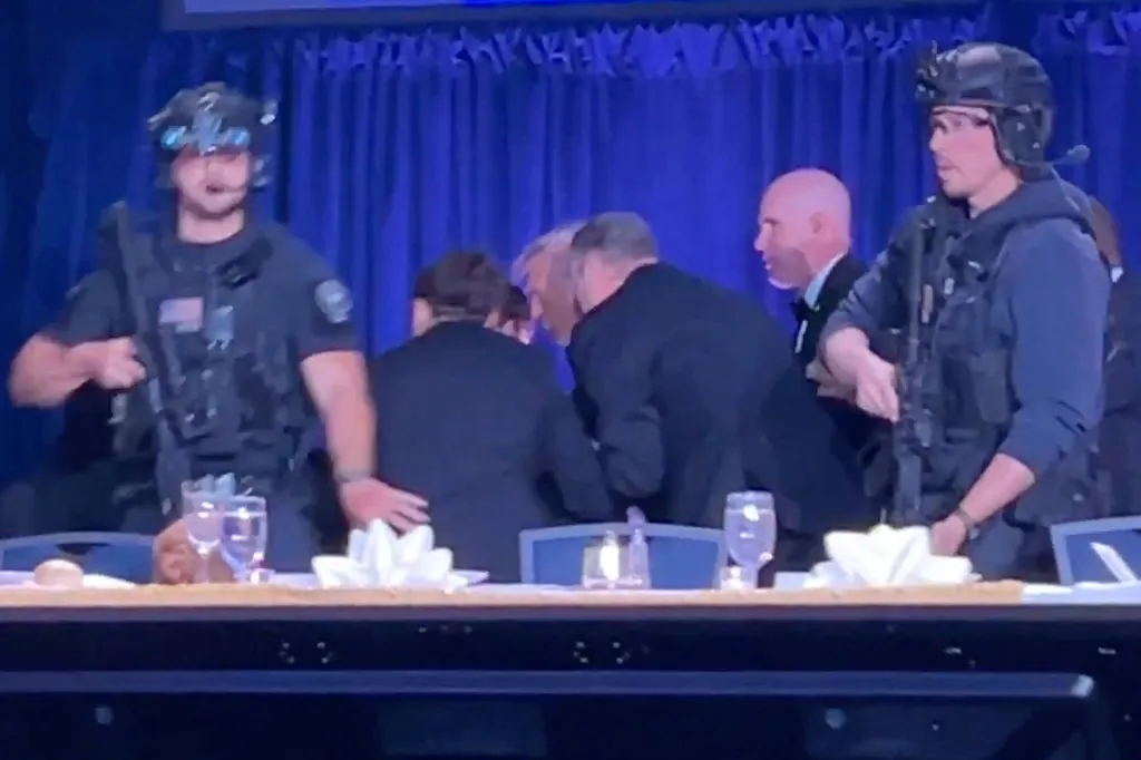 Secret Service agents rush President Donald Trump off the dais after a shooting inside the Washington Hilton hotel on April 25, 2026.