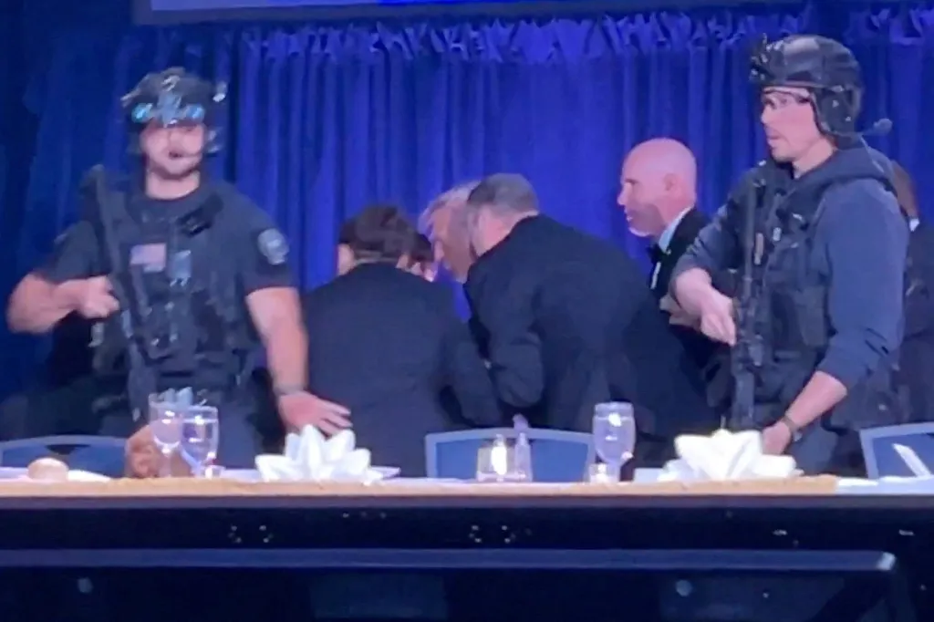 U.S. President Donald Trump is escorted out as a shooter opens fire during the annual White House Correspondents' Association dinner in Washington.
