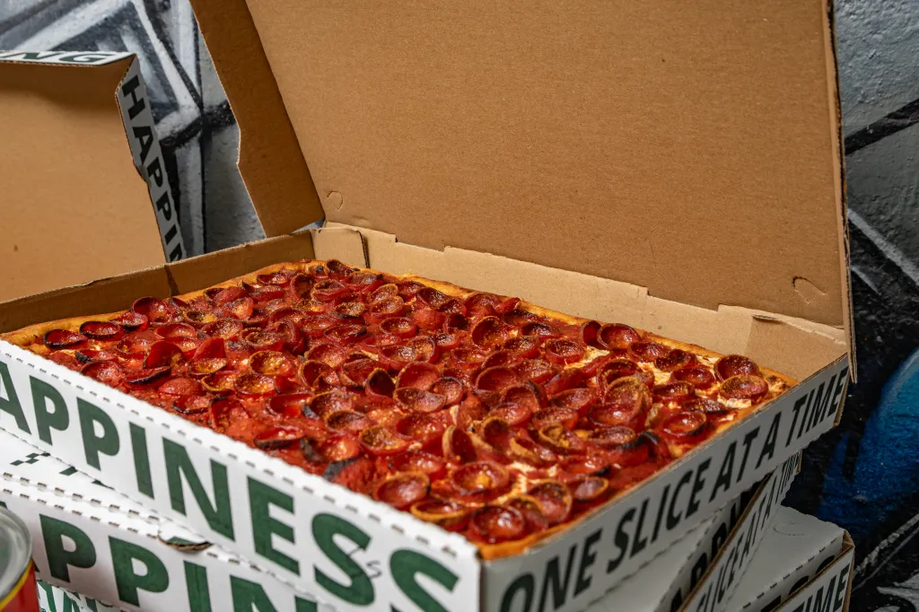 A square pepperoni pizza in a pizza box.