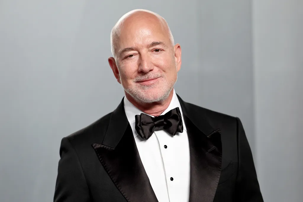 Jeff Bezos smiling in a tuxedo.