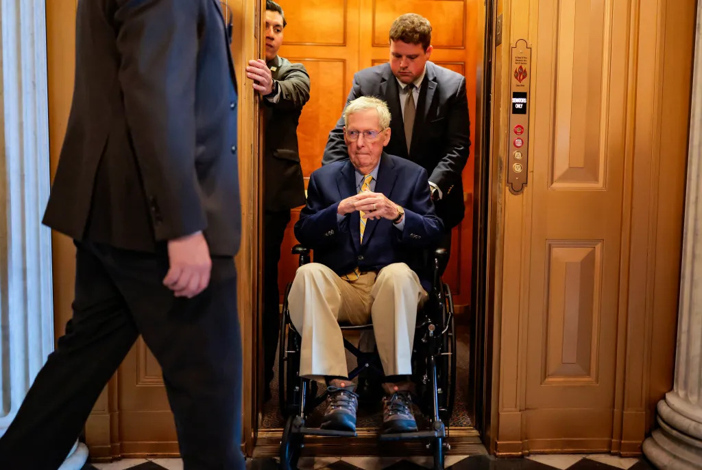 U.S. Sen. Mitch McConnell (R-KY) is pushed in a wheelchair during a vote at the U.S. Capitol Building.
