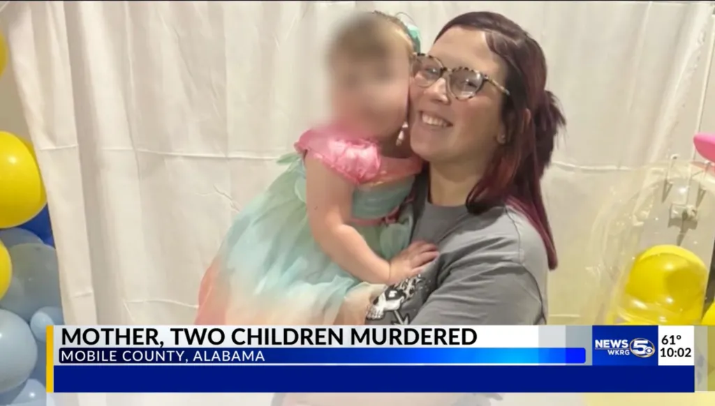 A smiling woman with glasses and dark red hair holds a blurred child in a light blue and pink dress. The text overlay reads, "MOTHER, TWO CHILDREN MURDERED MOBILE COUNTY, ALABAMA."