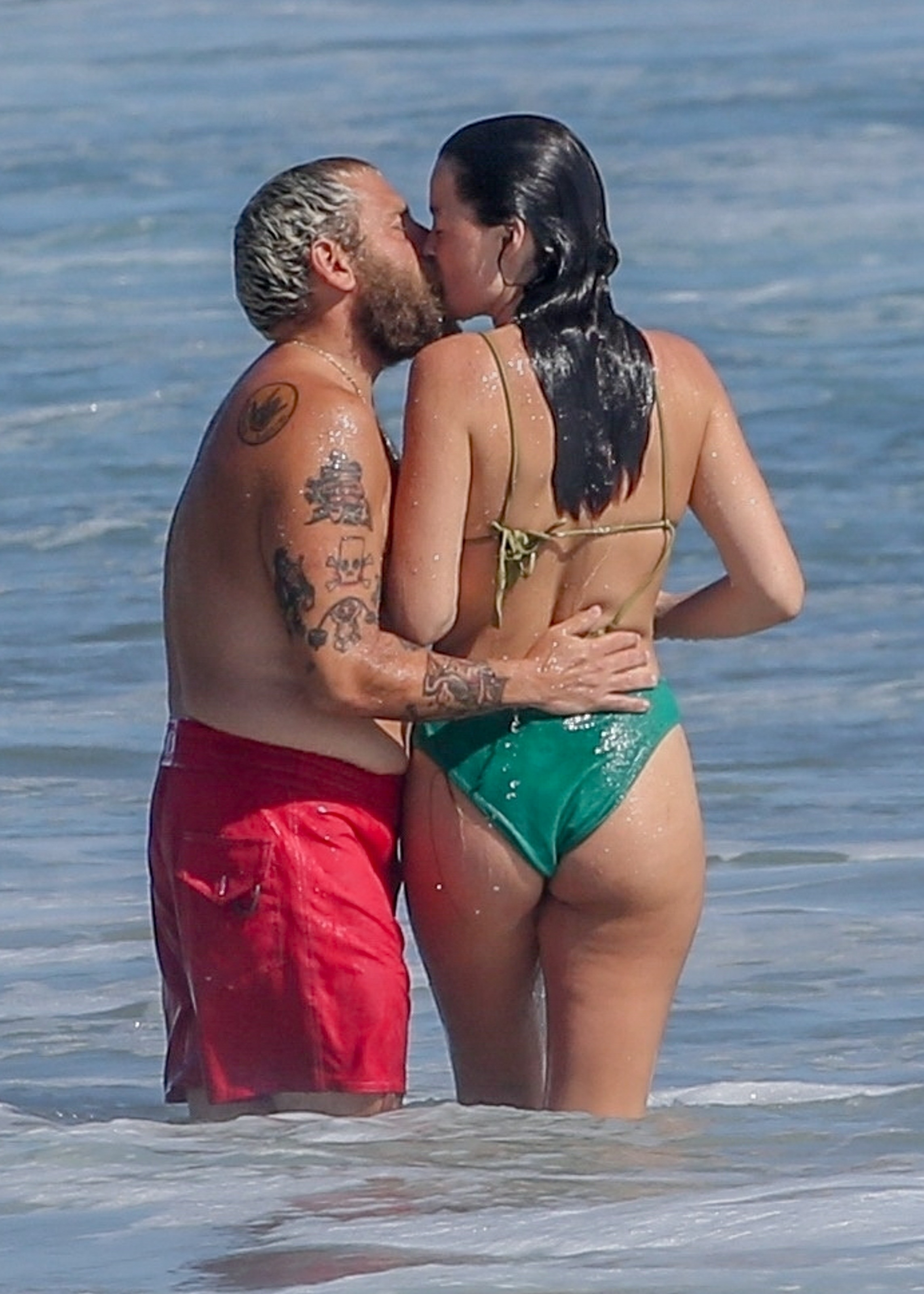 Jonah Hill and Olivia Millar kissing in the ocean.