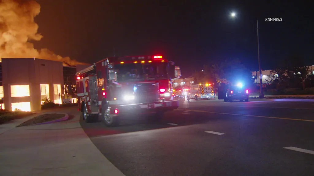 Firefighters and police respond to a warehouse fire on South Hellman Avenue.