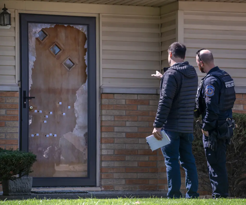 Investigators examine the scene of an early morning shooting at the home of City-County Councilman Ron Gibson.