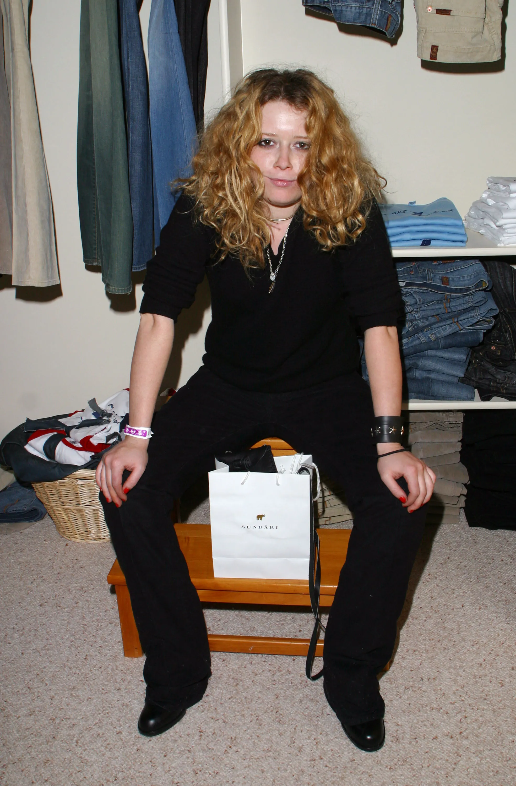 Natasha Lyonne sitting with a Sundari bag at the 7 for All Mankind Lodge.
