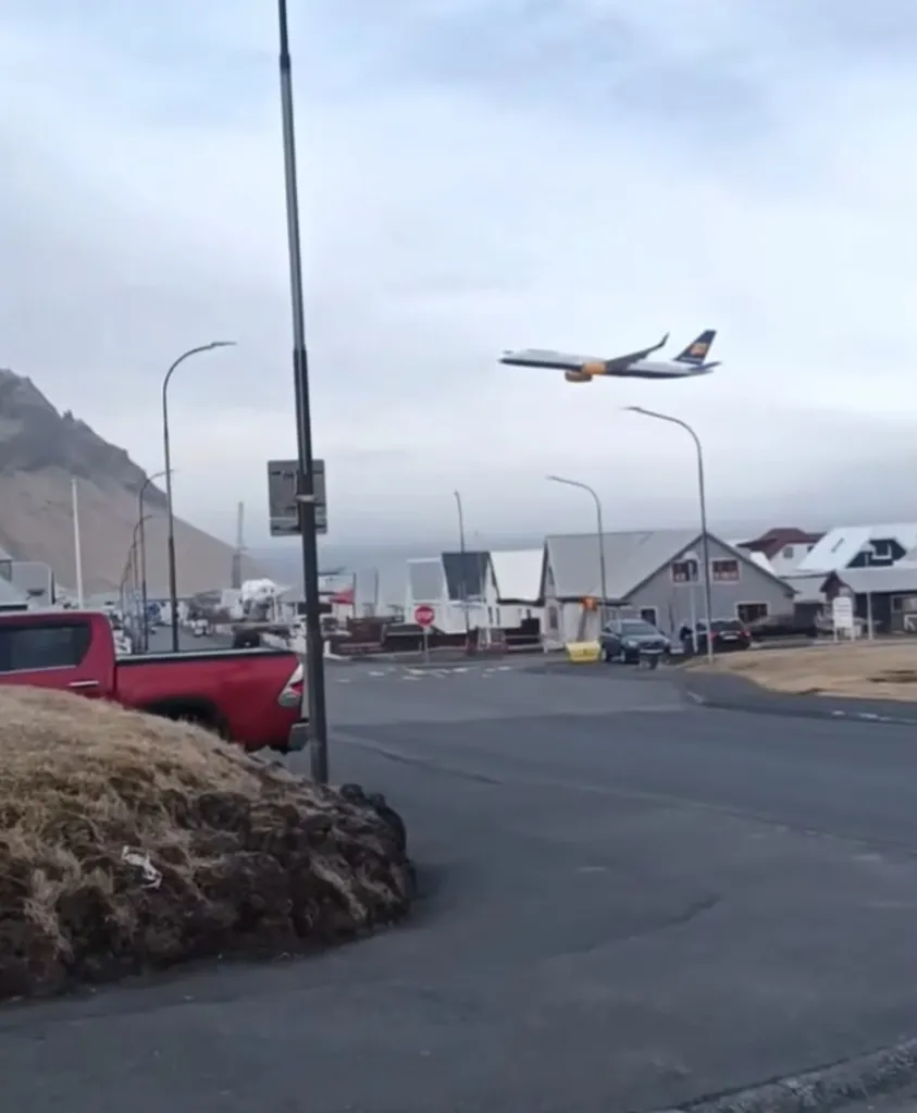 Plane flying low over town.