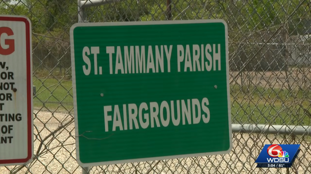 A green sign on a chain-link fence reads "ST. TAMMANY PARISH FAIRGROUNDS".