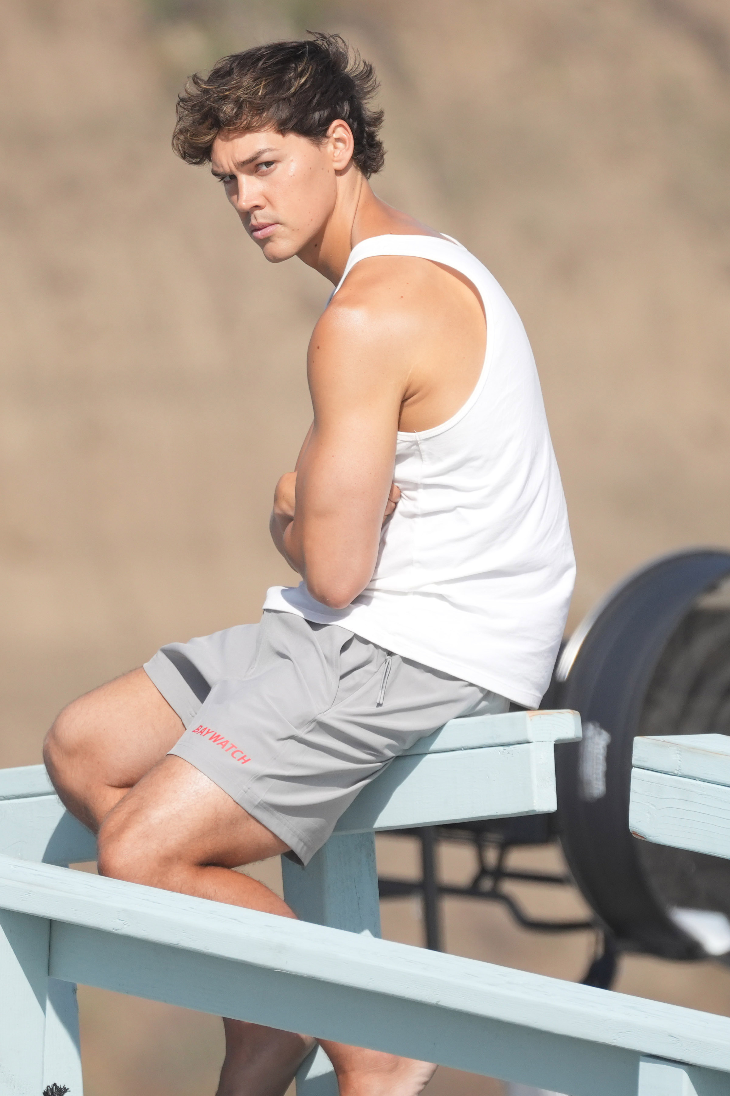 Actor Noah Beck Relaxes on The Lifeguard Tower Between Baywatch Scenes on Santa Monica Beach