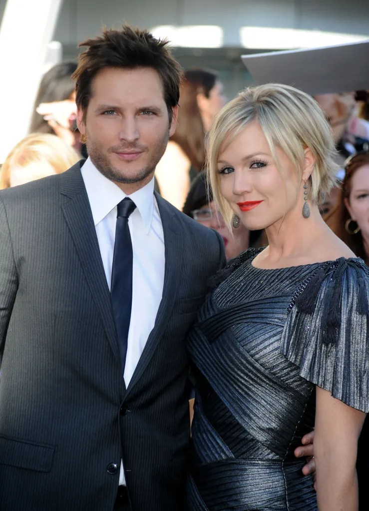 Actor Peter Facinelli , in a grey suit, grey tie and white shirt, and wife Jennie Garth, n a grey dress, at an event.